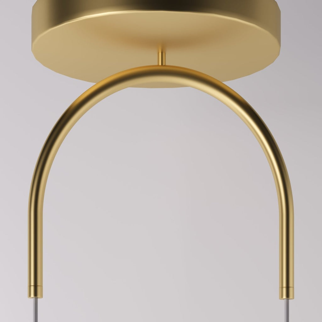 Clérachic pendant light detail in gold, a close-up on the arched two-cord ceiling canopy against a grey studio backdrop.