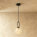 Clérachic black-hardware pendant light with a round alabaster globe, hung low on a slim rod from the ceiling.