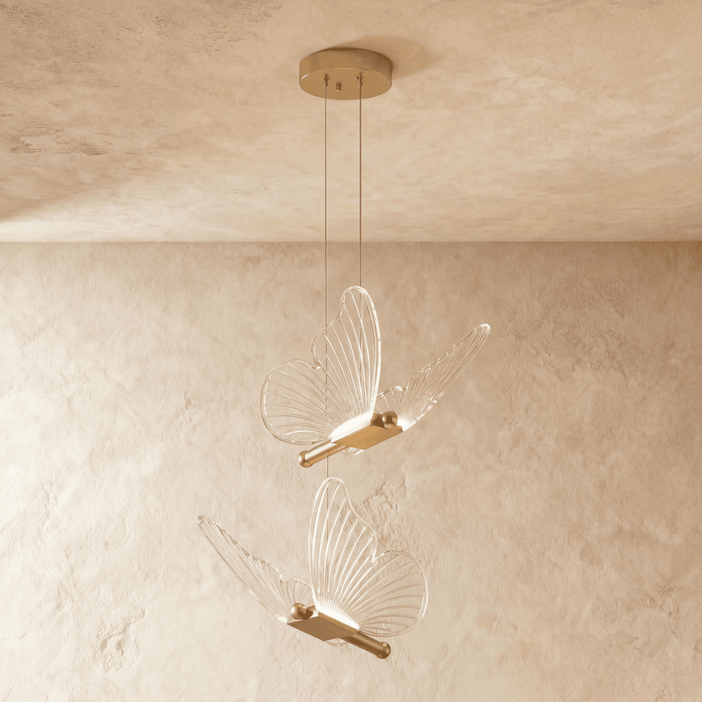 Clérachic brass butterfly pendant light with two clear ribbed-wing fixtures hanging from a round ceiling canopy.