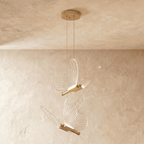 Clérachic brass butterfly pendant light with two clear ribbed-wing fixtures hanging from a round ceiling canopy.