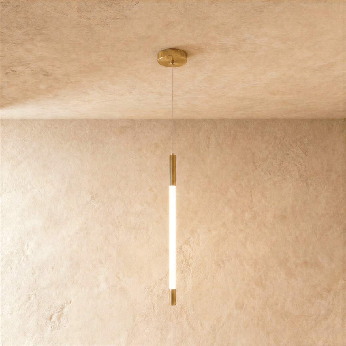 Clérachic slim gold pendant with a glowing opal rod between brass end caps, hung from a round ceiling plate on a fine wire.