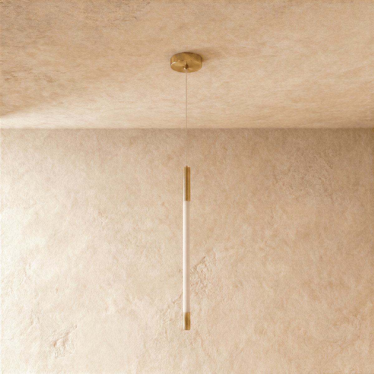 Clérachic gold pendant with an unlit opal rod between brass end caps, hanging from a round gold ceiling canopy on thin wire.