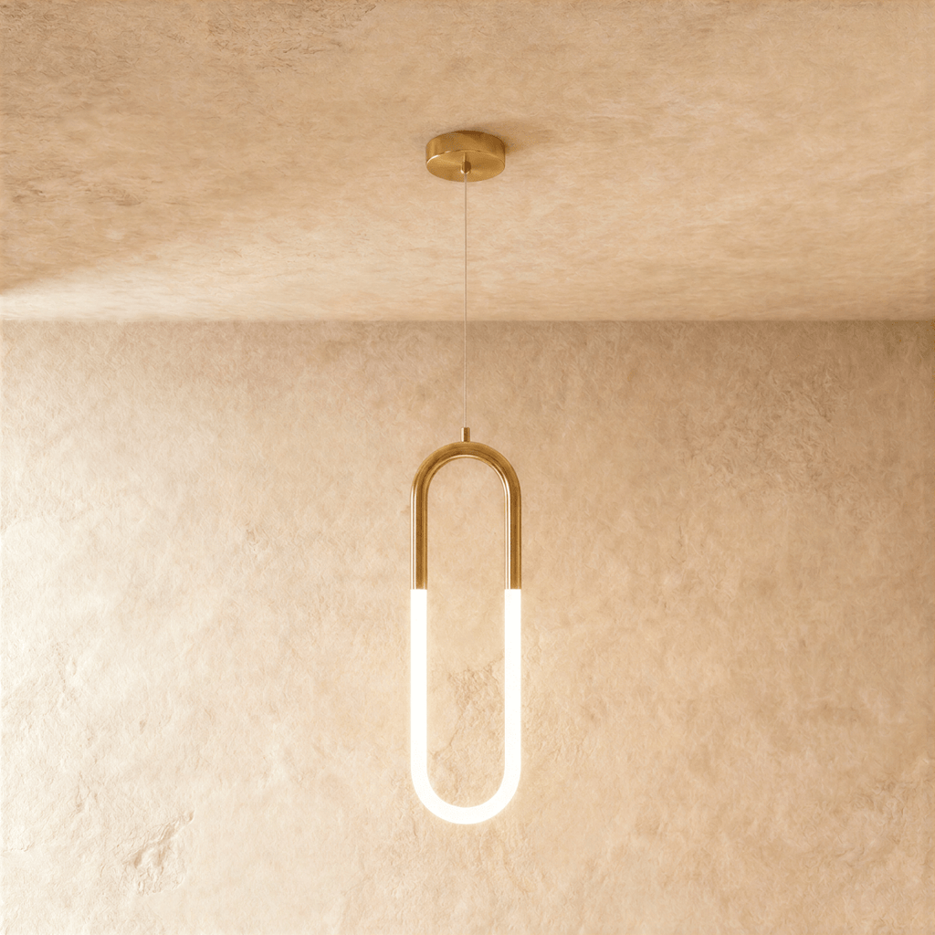 Clérachic gold pendant with an elongated U-shaped frame and glowing opal tube below, on a wire from a round canopy.