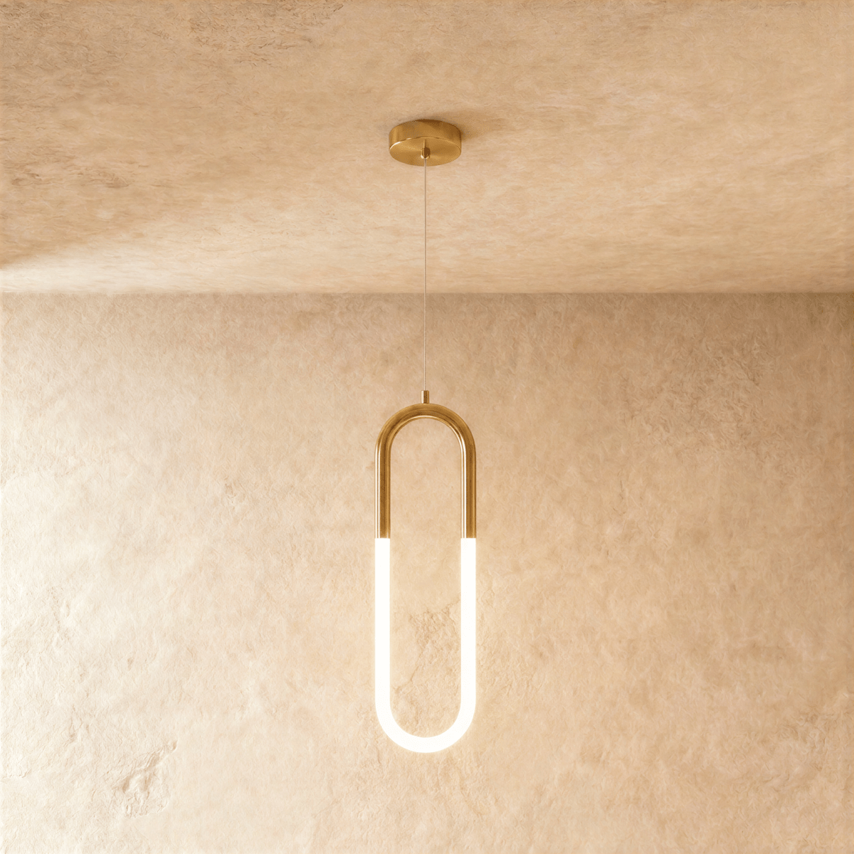 Clérachic gold pendant with an elongated U-shaped frame and glowing opal tube below, on a wire from a round canopy.