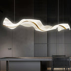 This Clérachic pendant lit against a charcoal slatted wall, its white wave shape glowing over a dark table with a woven chair.