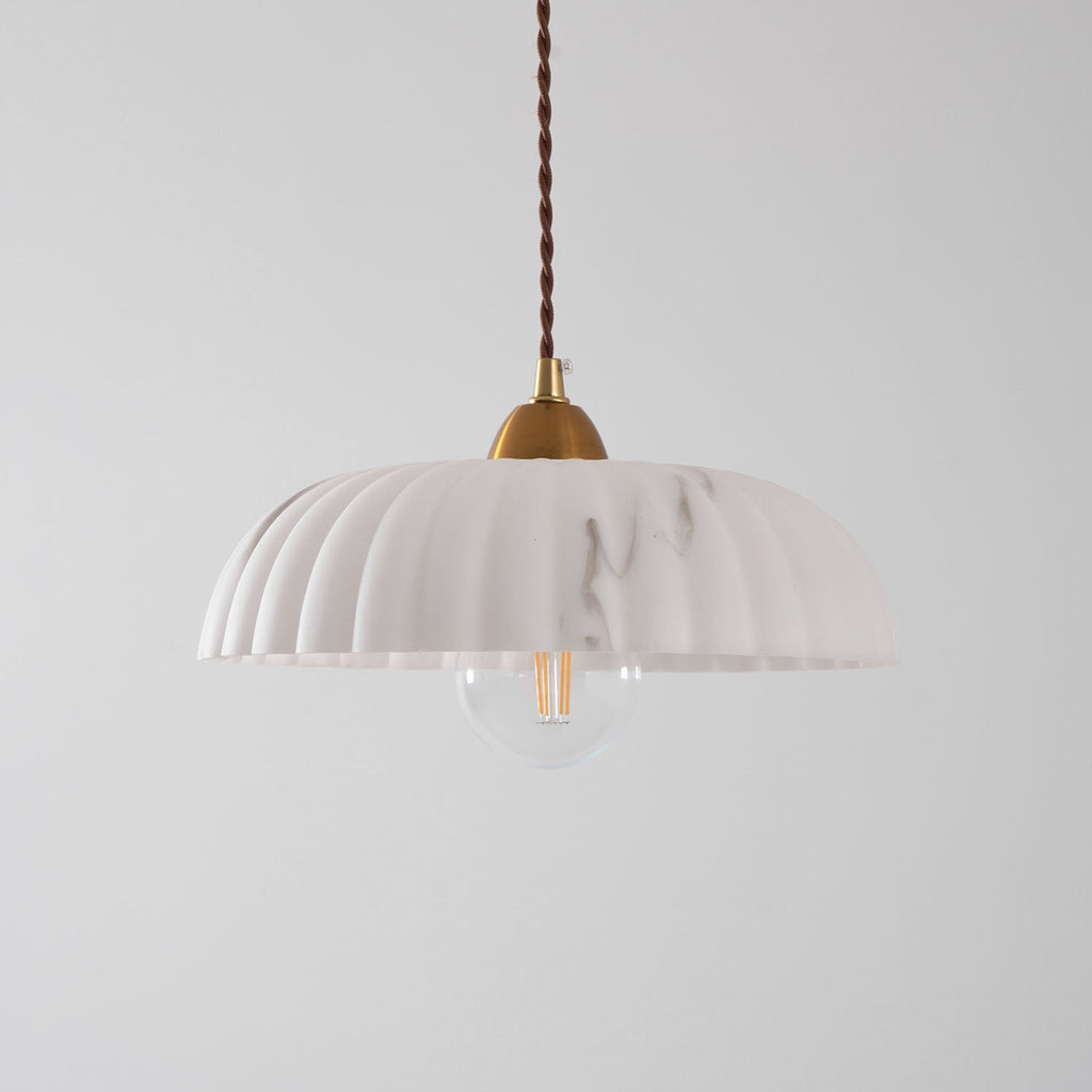 A paler white version of this Clérachic pendant, unlit, with a ribbed shade, grey veining and a clear filament bulb.