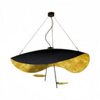 Product shot of the Clérachic gold pendant light on white, its black saucer shade curved open to show gold-leaf lining.