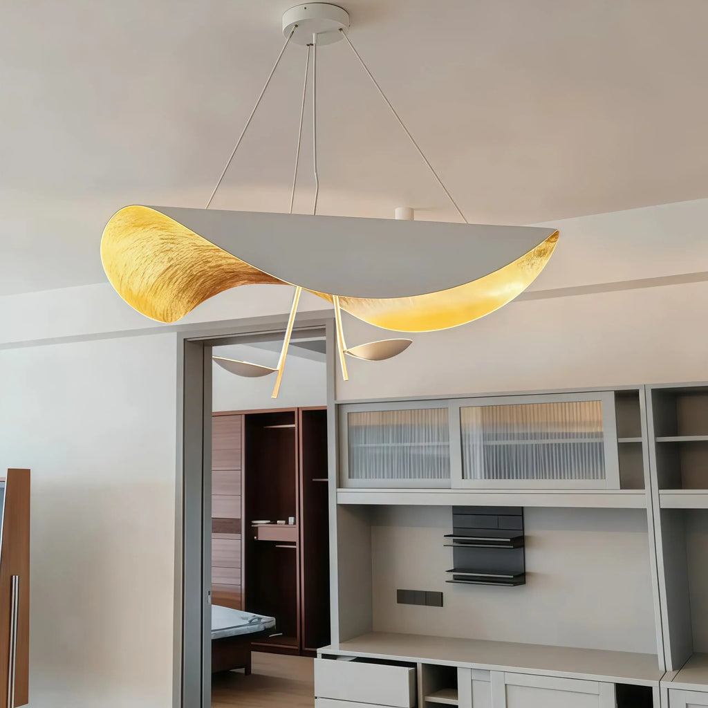 Studio shot of the Clérachic pendant light in black, its shade lit from within to show the gold-leaf glow and two accent discs.