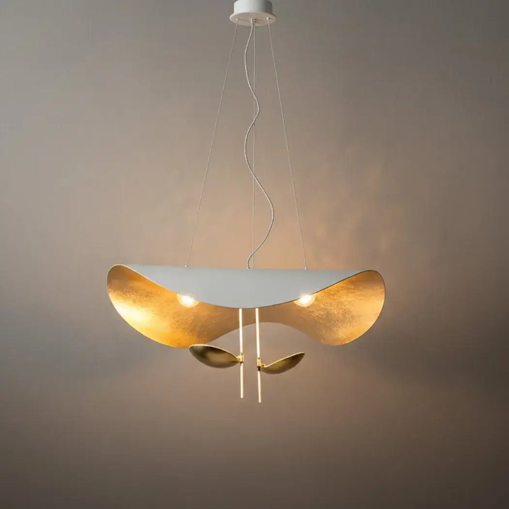 Studio shot of the white Clérachic pendant light with its integrated LED discs exposed and two gold accent discs hanging below.