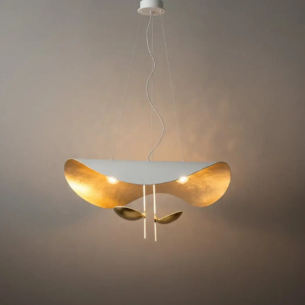 Studio shot of the white Clérachic pendant light with its integrated LED discs exposed and two gold accent discs hanging below.