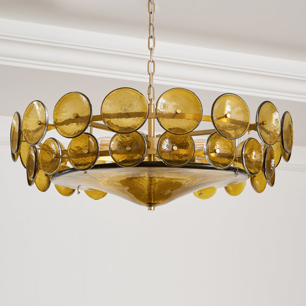 Side view of this Clérachic chandelier, with two rings of green-gold textured glass discs and a shallow glass bowl beneath the gold frame.