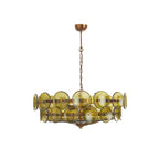 Green and gold Clérachic chandelier with olive glass discs in two tiers, hanging on a chain against a white backdrop.