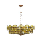 Compact green and gold Clérachic chandelier, olive glass discs around an aged brass frame, on a white background.