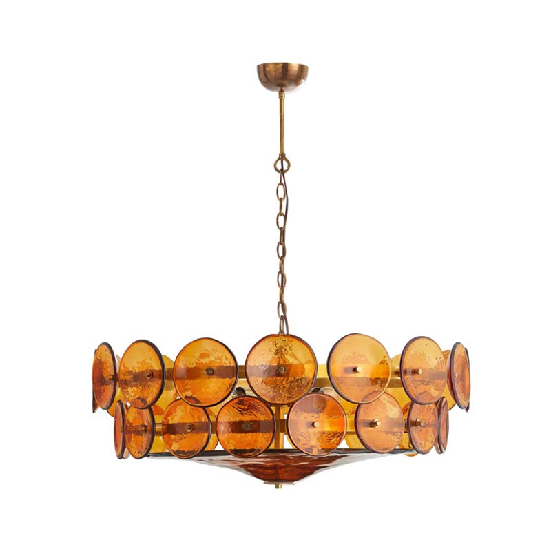 Amber disc chandelier from Clérachic with a smaller spread, hanging by a brass chain against plain white.