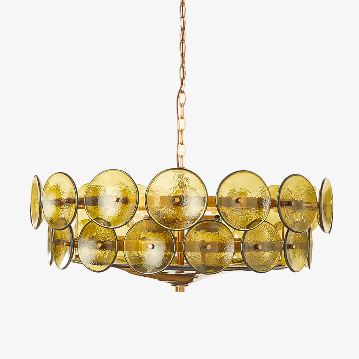 Green-gold glass disc chandelier from Clérachic, close in, with its chain rising out of frame against a pale grey backdrop.