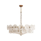 White frosted disc chandelier from Clérachic with swirled glass and a gold frame, hanging against a plain white background.