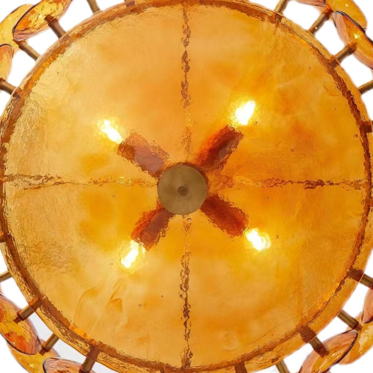 Looking up into the glowing amber bowl of this Clérachic chandelier, with four lit bulbs and a cross-shaped brass fitting.
