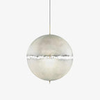 White frosted sphere with a jagged clear band around its middle, on a thin cord with a gold-toned stem, this Clérachic pendant on a plain backdrop.