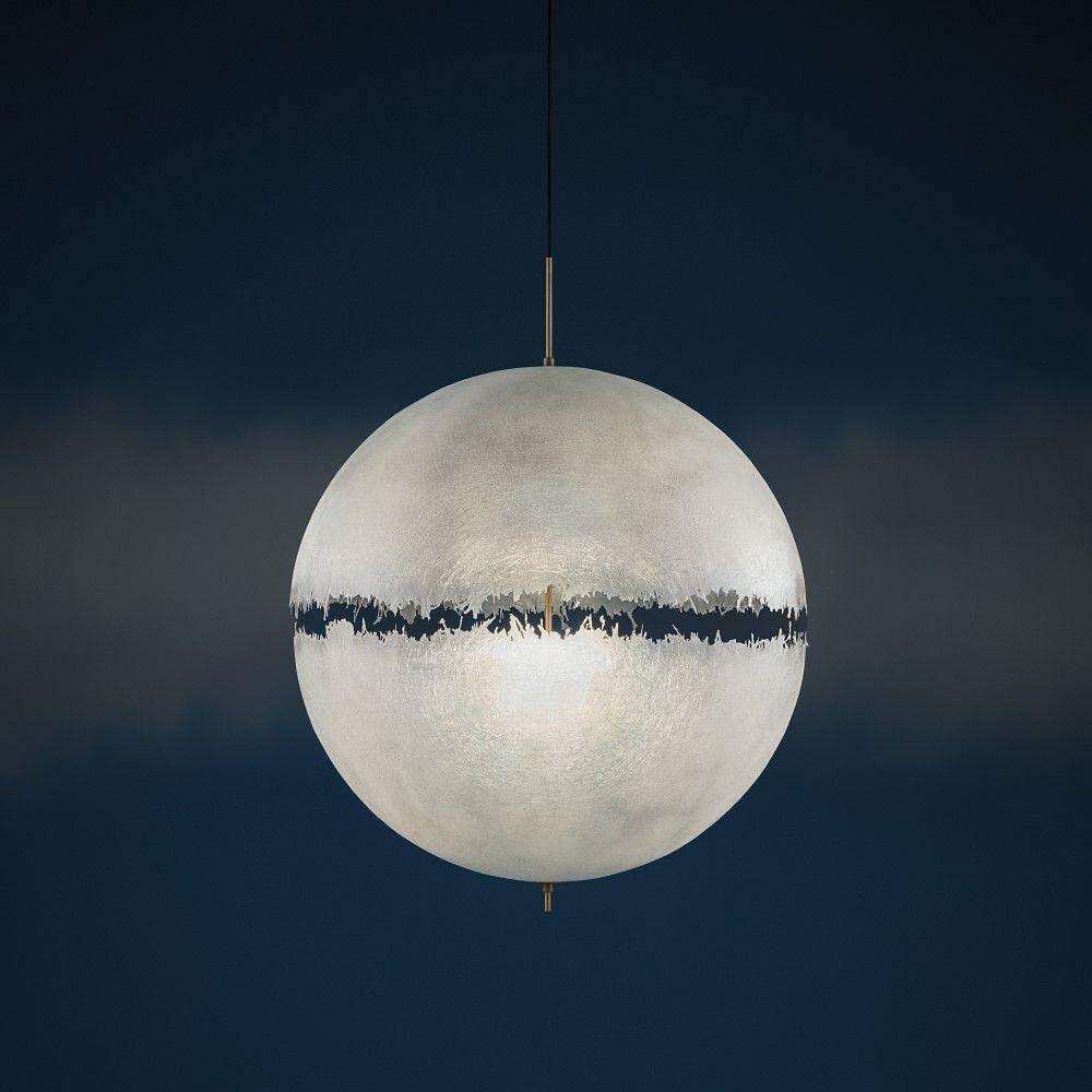 Frosted sphere with a dark jagged band around the middle, this Clérachic pendant against a deep navy backdrop.