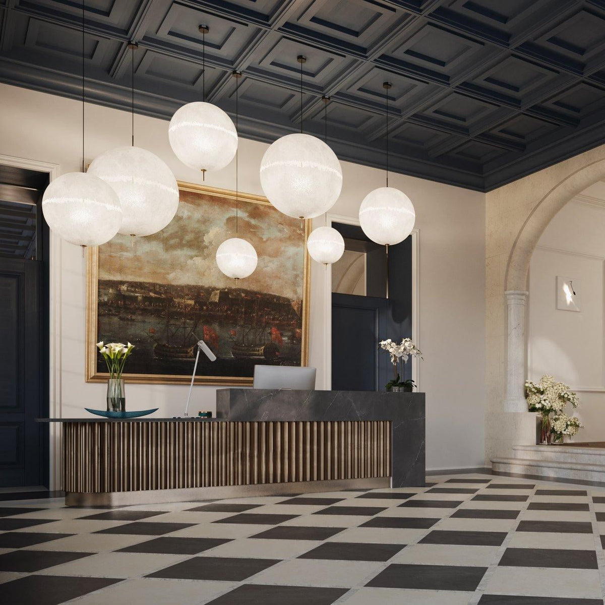 This Clérachic pendant's spheres seen from the entrance, hanging over a long reception desk and a black-and-white chequered floor.