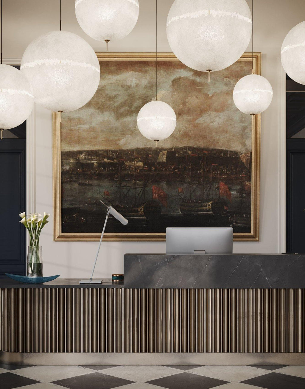 Large and small white spheres from this Clérachic pendant hang beside a painting and a reception desk, shown in a tall portrait view.
