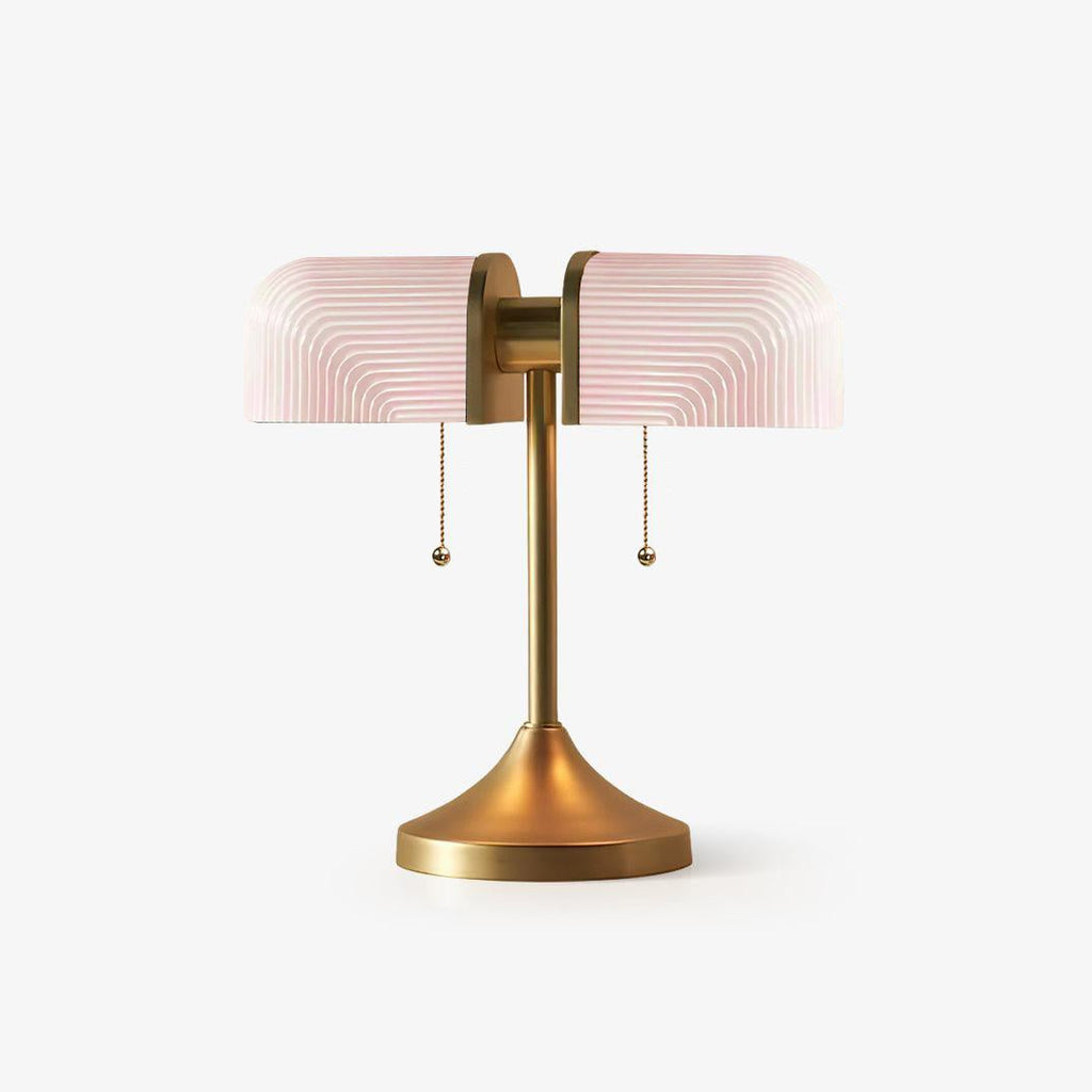 Pictured here, a Clérachic gold table lamp with pale pink ribbed glass shades, unlit, on a plain white backdrop.