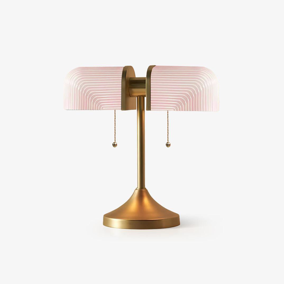 Pictured here, a Clérachic gold table lamp with pale pink ribbed glass shades, unlit, on a plain white backdrop.