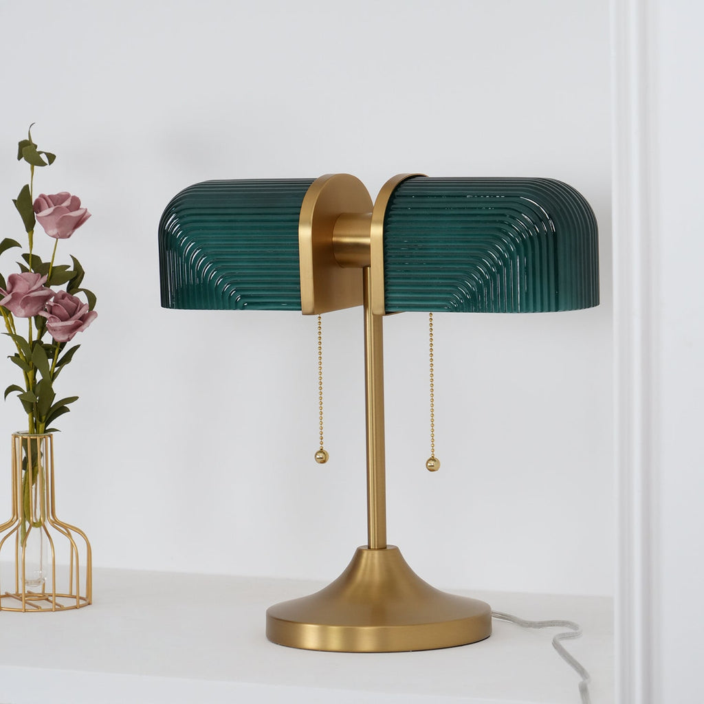 Close view of the dark green ribbed glass shades on this Clérachic gold table lamp, with its two pull chains and flared base.