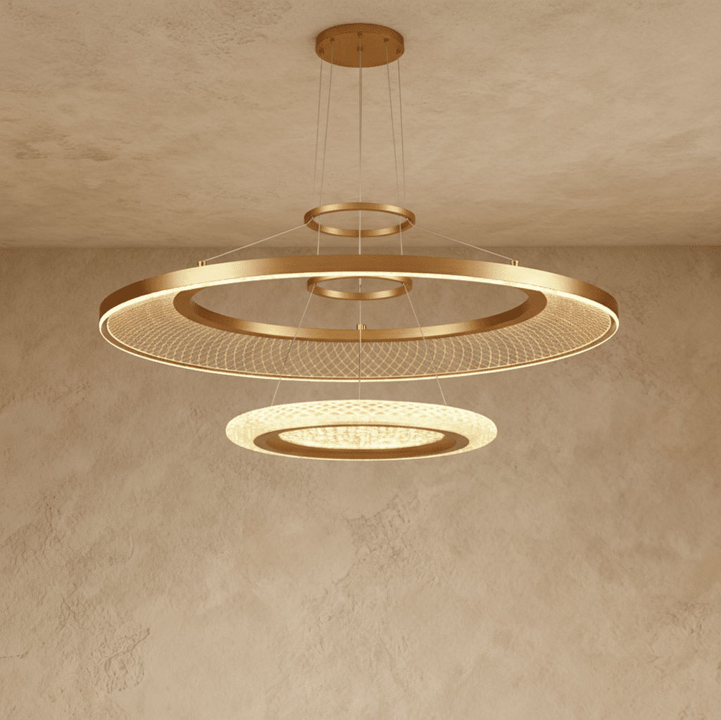 Clérachic two-ring brushed gold LED chandelier with a large mesh-filled ring above a smaller glowing disc, on a ceiling canopy.