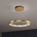 Gold Clérachic ring pendant light with clear glass pieces inside the band, seen from slightly below against a grey ceiling.