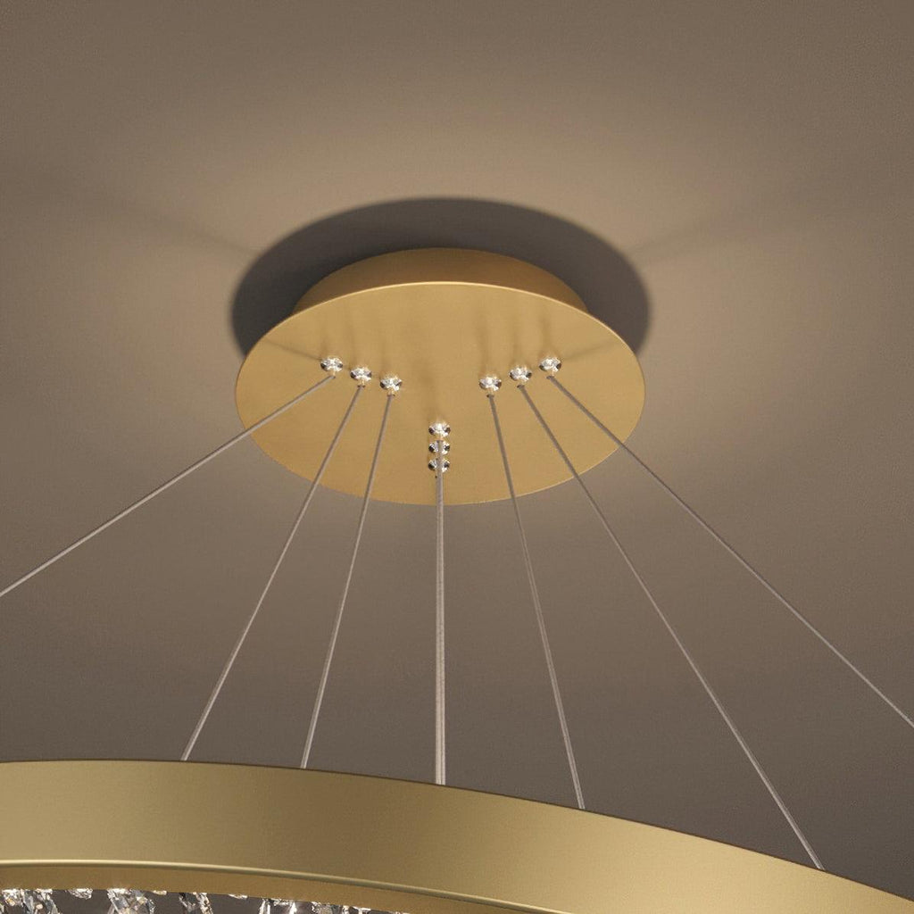 Close view of the gold ceiling plate and the cables running down to the ring on this Clérachic pendant light.