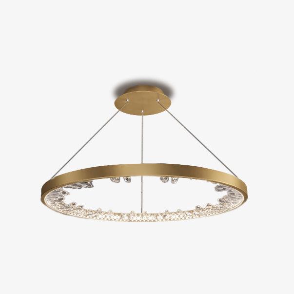 Gold Clérachic ring pendant light with a slim band and clear glass pieces inside, hung from a small ceiling plate on a pale background.