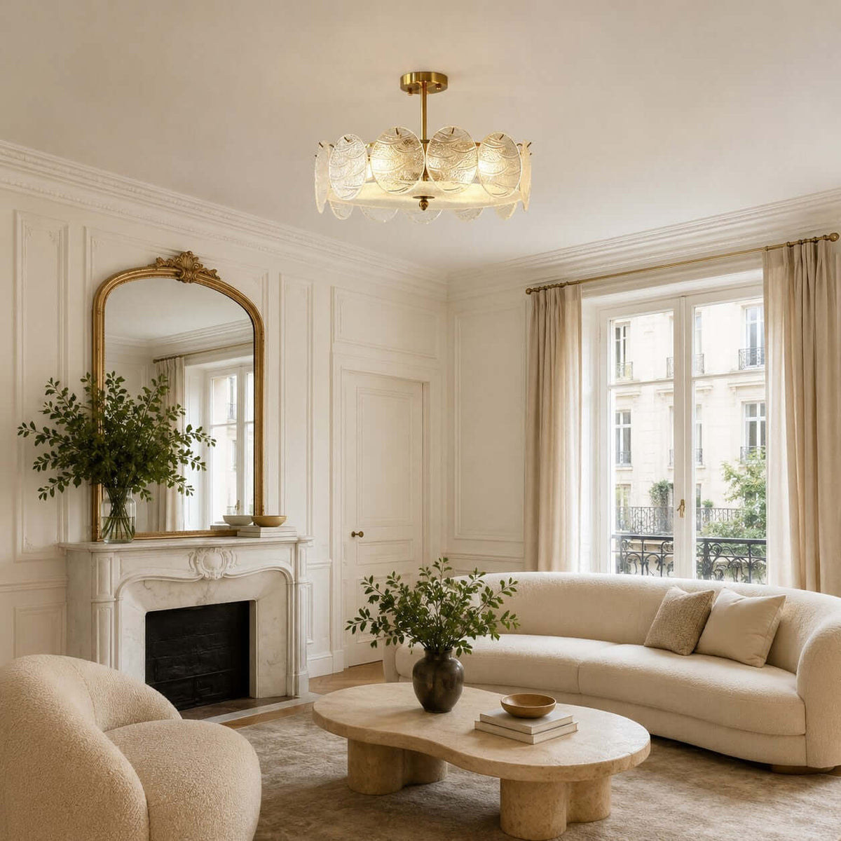 Glass disc Clérachic ceiling light above a living room with a marble fireplace, a gilt mirror and a curved cream sofa.