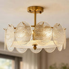 Close view of the rippled glass discs and brass canopy on this Clérachic semi flush ceiling light, lit warmly with a blurred room behind.