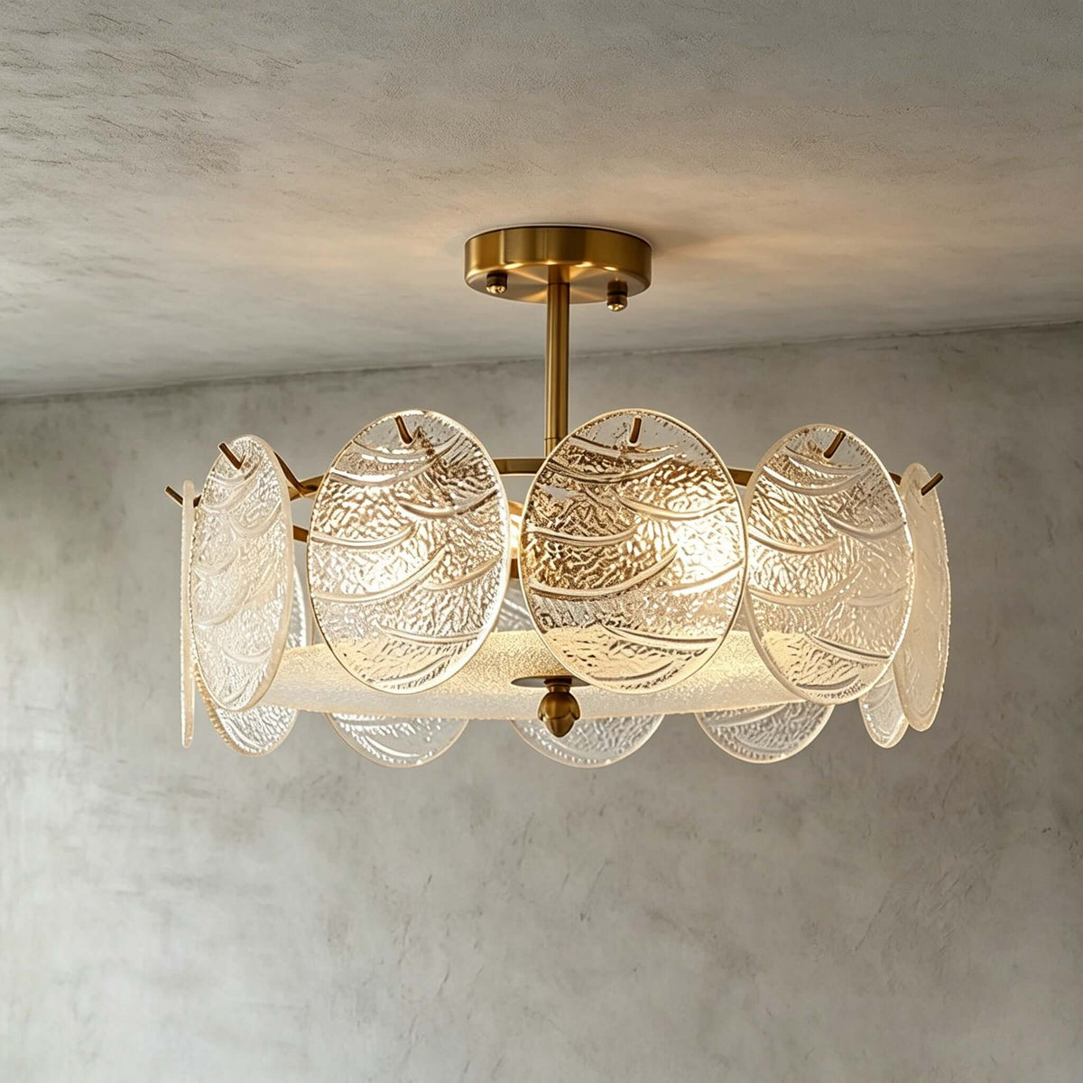 Front view of a lit Clérachic ceiling light with textured glass discs and a gold stem against a grey limewash wall and ceiling.