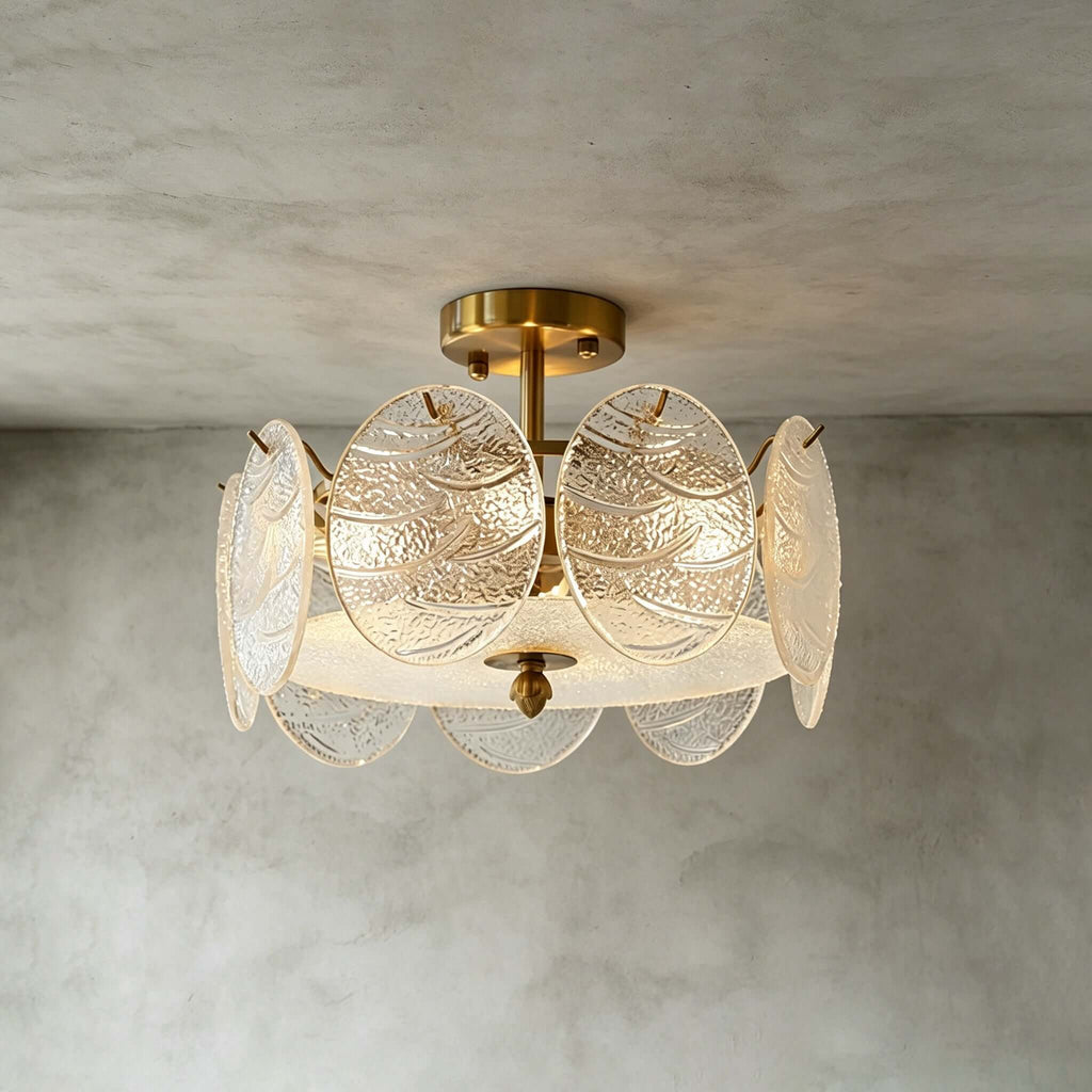 Slightly lower angle on a Clérachic gold semi flush light, showing the rippled glass discs and frosted base against a grey wall.