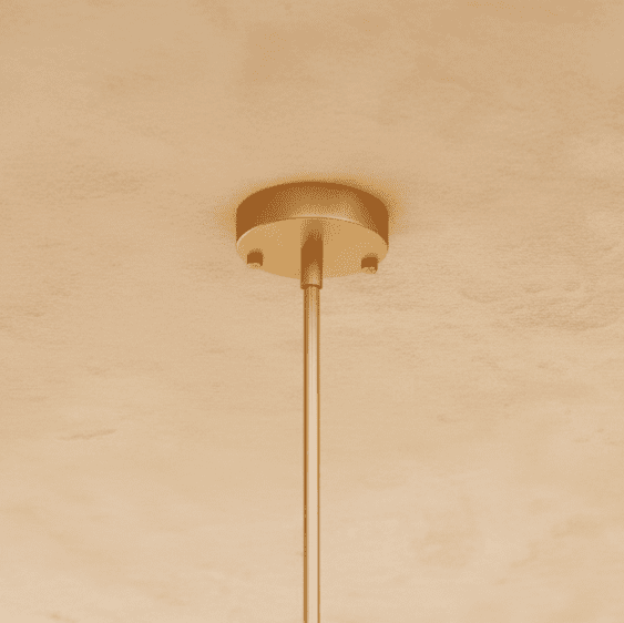 Clérachic gold ceiling canopy and slim rod, the round plate fixed with two screws on a warm plaster ceiling.