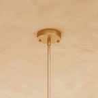 Clérachic gold ceiling canopy and slim rod, the round plate fixed with two screws on a warm plaster ceiling.