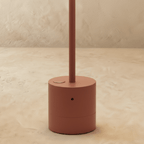 Clérachic table lamp base detail in terracotta, showing the touch button and slim stem on the cylindrical base.