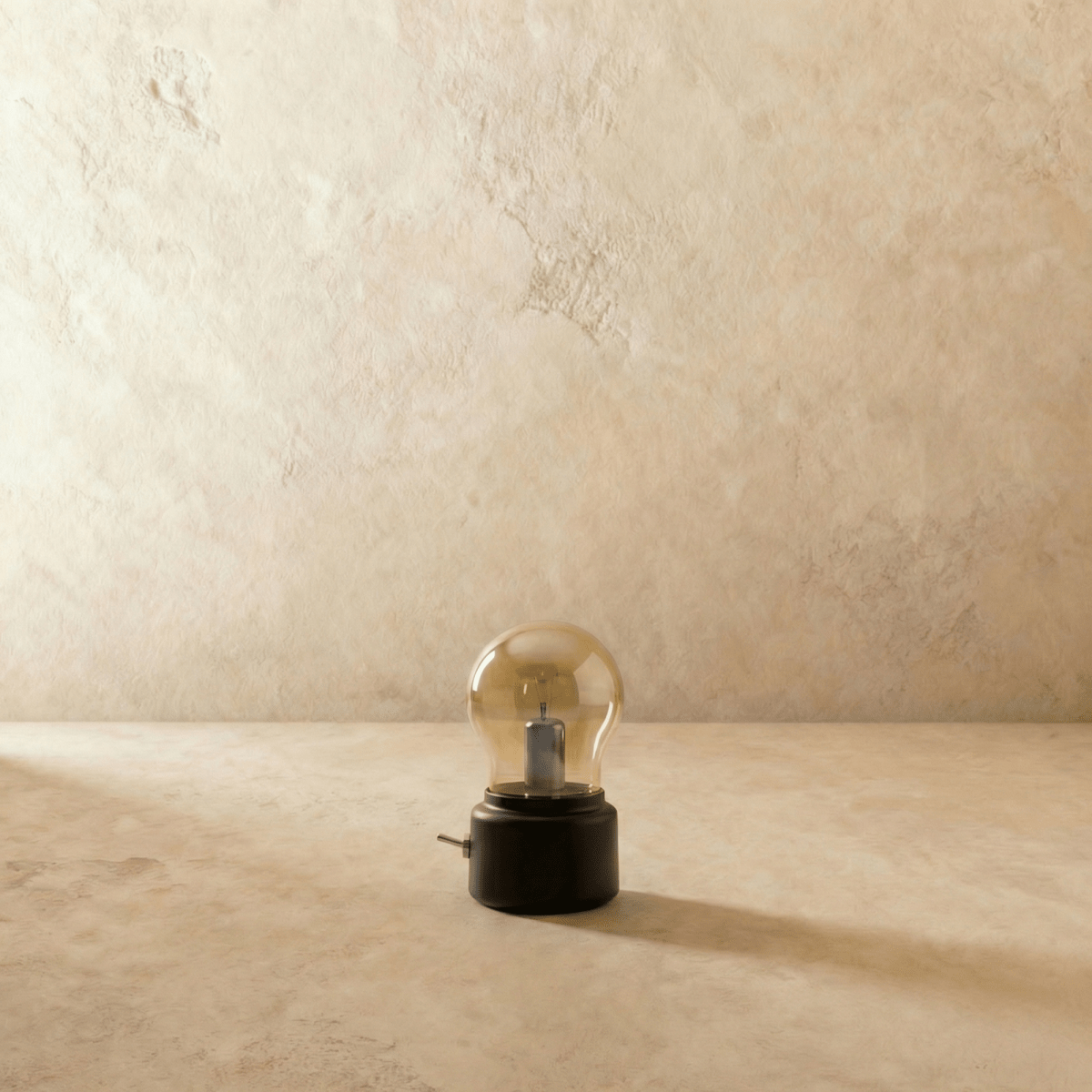 Clérachic's table lamp in a black base sits unlit, its clear glass bulb shade catching the light.