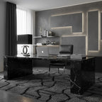Clérachic table lamp with a black shade on a black marble desk in a grey home office, with a laptop and a leather chair behind it.