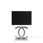 A Clérachic chrome table lamp with a black shade and a mirror-polished base, on white, with a white cord trailing to the right.