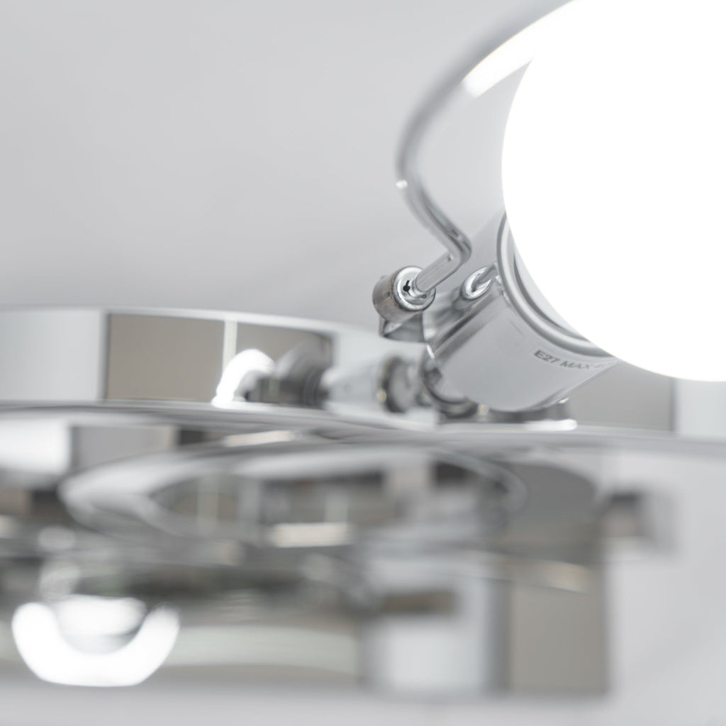 Close view from underneath of the bulb holder and the shiny steel parts inside the shade of this Clérachic table lamp.