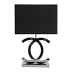 Clérachic table lamp with a black rectangular shade over dark chrome loops on a polished steel base, on a white backdrop.