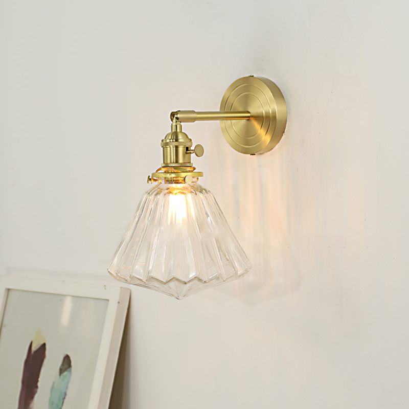 Clérachic Gold Vanity Wall Sconce with the flower-shaped fluted glass shade and a warm filament bulb.