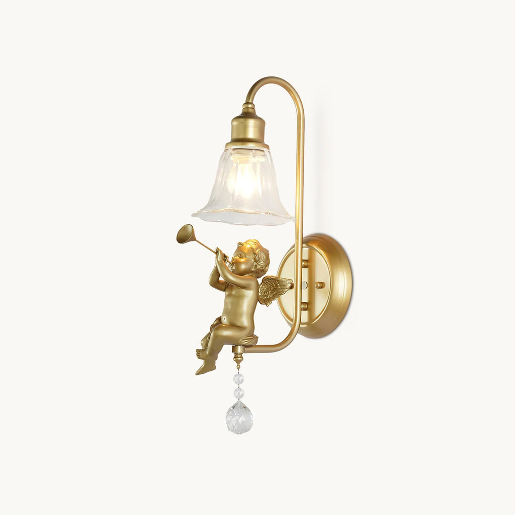 Gold wall light from Clérachic with a cherub blowing a trumpet beneath a clear bell shade, on a plain white backdrop.