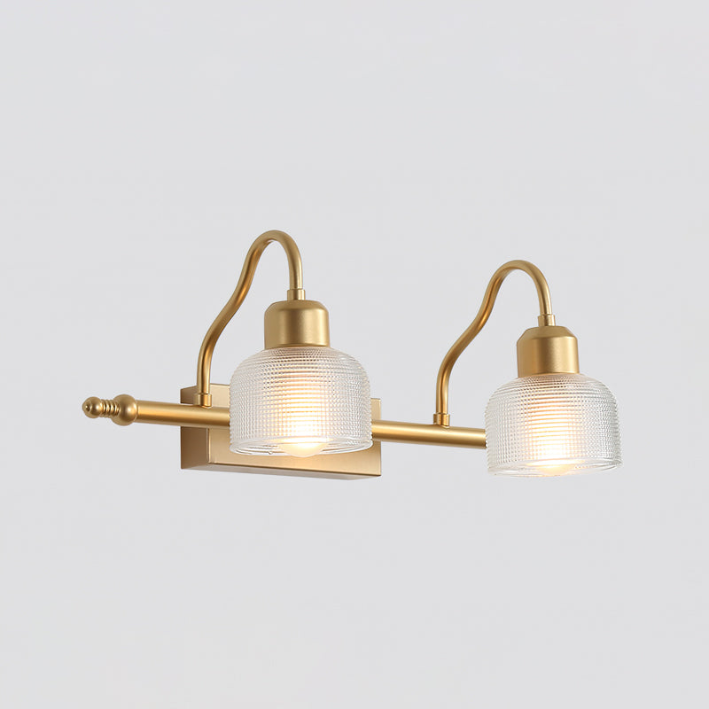 Two-light Clérachic wall lamp in close framing, with large clear ribbed glass shades hanging from gently curved gold arms.