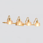 Four-light Clérachic wall lamp with warm amber ribbed glass shades lit along a slim gold bar, on a pale grey background.