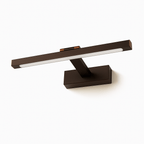 Clérachic wall lamp in bronze-brown, unlit, showing its slim bar and rectangular wall plate.