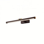 Clérachic wall lamp in bronze-brown with brass end caps, its LED strip lit softly along the bar in a studio shot.